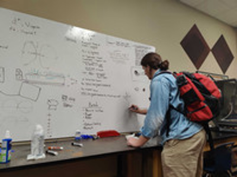 Team Pleiades member works through engineering equations